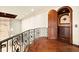 Upstairs hallway showcases wrought iron details and arched entry to another room at 21321 Harborside Blvd, Port Charlotte, FL 33952