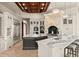 Gourmet kitchen boasts a wood-coffered ceiling, stone range hood, double islands, and stainless steel appliances at 21321 Harborside Blvd, Port Charlotte, FL 33952