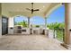 Luxury outdoor kitchen with stainless steel appliances and a covered patio at 21321 Harborside Blvd, Port Charlotte, FL 33952