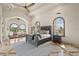 A spacious primary bedroom features a decorative ceiling, tile flooring, arched windows, and a sitting area at 21321 Harborside Blvd, Port Charlotte, FL 33952