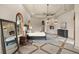 A spacious primary bedroom featuring tile floors, tray ceilings, a fireplace, and arched windows at 21321 Harborside Blvd, Port Charlotte, FL 33952