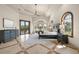 Primary bedroom featuring tile flooring, arched windows, a sitting area, and access to the outdoor patio at 21321 Harborside Blvd, Port Charlotte, FL 33952