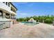 Backyard showcasing a pristine pool, sun deck, and lush landscaping for ultimate relaxation and entertainment at 21321 Harborside Blvd, Port Charlotte, FL 33952