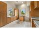 Bright laundry room with ample cabinetry and granite countertops at 21321 Harborside Blvd, Port Charlotte, FL 33952