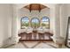 Sitting area with wood flooring, arched windows, and white armchairs adjacent to the main bedroom at 21321 Harborside Blvd, Port Charlotte, FL 33952