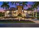 Mediterranean style home with landscaping and a paved driveway at 21321 Harborside Blvd, Port Charlotte, FL 33952