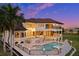 Luxury pool and spa with travertine decking and home view at 21321 Harborside Blvd, Port Charlotte, FL 33952