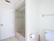 Bathroom with a shower-tub combo, a toilet, and a white door at 24313 Pirate Harbor Blvd, Punta Gorda, FL 33955