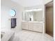 Bright bathroom with double vanity, walk-in shower, and unique octagon-shaped window at 24313 Pirate Harbor Blvd, Punta Gorda, FL 33955