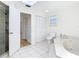 Bathroom featuring tile floors, a tub, a shower and a double closet at 24313 Pirate Harbor Blvd, Punta Gorda, FL 33955