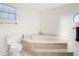 Bright bathroom features a large soaking tub and a window for natural light at 24313 Pirate Harbor Blvd, Punta Gorda, FL 33955