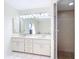 Bathroom with double sinks, large mirror, a sky light and a tiled walk-in shower at 24313 Pirate Harbor Blvd, Punta Gorda, FL 33955