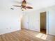 Bedroom features a ceiling fan, closet, and light wood laminate flooring at 24313 Pirate Harbor Blvd, Punta Gorda, FL 33955