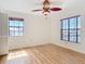 Bedroom with wood flooring, a ceiling fan and large windows that give great light at 24313 Pirate Harbor Blvd, Punta Gorda, FL 33955