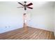 Spacious bedroom with hardwood floors, a ceiling fan, and a doorway leading to another room at 24313 Pirate Harbor Blvd, Punta Gorda, FL 33955