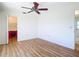 Bright bedroom with a ceiling fan, light wood floors and neutral walls at 24313 Pirate Harbor Blvd, Punta Gorda, FL 33955