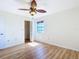 Bedroom features a ceiling fan, window, and closet with a bright atmosphere at 24313 Pirate Harbor Blvd, Punta Gorda, FL 33955