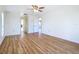 Bedroom with wood floors, access to a closet and bathroom, and neutral paint at 24313 Pirate Harbor Blvd, Punta Gorda, FL 33955