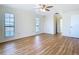 Bedroom featuring wood flooring, two windows, and convenient access to a closet and bathroom at 24313 Pirate Harbor Blvd, Punta Gorda, FL 33955