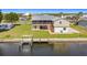 Aerial view of waterfront property with a canal and a dock at 24313 Pirate Harbor Blvd, Punta Gorda, FL 33955