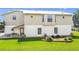 A charming two-story home shows a freshly manicured lawn and neutral tones at 24313 Pirate Harbor Blvd, Punta Gorda, FL 33955