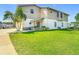 Well-maintained, two-story home with lush green lawn and inviting curb appeal at 24313 Pirate Harbor Blvd, Punta Gorda, FL 33955