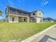 Waterfront exterior with green grass, stairs to an outdoor porch, and canal views at 24313 Pirate Harbor Blvd, Punta Gorda, FL 33955