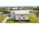 Two-story home with mature palm trees, canal access and boat dock at 24313 Pirate Harbor Blvd, Punta Gorda, FL 33955