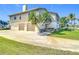 Two-story home with two-car garage, palm trees, and well-kept front yard at 24313 Pirate Harbor Blvd, Punta Gorda, FL 33955