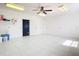 Spacious garage with tiled flooring, bright lighting, and extra storage at 24313 Pirate Harbor Blvd, Punta Gorda, FL 33955