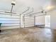Garage with a large door for vehicles and additional storage space, plus access to the house at 24313 Pirate Harbor Blvd, Punta Gorda, FL 33955