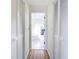 Hallway with closet doors, leading to bathroom with a skylight and marble features at 24313 Pirate Harbor Blvd, Punta Gorda, FL 33955