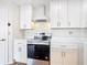 White kitchen with stainless steel oven range and marble countertops at 24313 Pirate Harbor Blvd, Punta Gorda, FL 33955