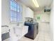 Functional laundry room with modern appliances, storage shelving, and a sink at 24313 Pirate Harbor Blvd, Punta Gorda, FL 33955