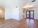 Open-concept room featuring light wood flooring and French doors at 24313 Pirate Harbor Blvd, Punta Gorda, FL 33955