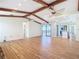 Large living room with exposed beams, wood flooring, and sliding glass doors to the exterior at 24313 Pirate Harbor Blvd, Punta Gorda, FL 33955