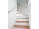 Hardwood stairs feature white risers and handrails at 24313 Pirate Harbor Blvd, Punta Gorda, FL 33955