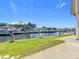 Backyard waterfront featuring seawall, green grass, and boat dock at 24313 Pirate Harbor Blvd, Punta Gorda, FL 33955