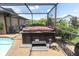 Relaxing hot tub with a wooden cover and stone accents at 301 Thorn Hill Pl, Sun City Center, FL 33573