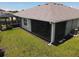 Aerial view of the backyard with a screened lanai, conservatory, and well-maintained lawn at 7168 W Lenox Cir, Punta Gorda, FL 33950
