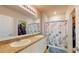 Spacious bathroom with double vanity, large mirror, and stylish shower curtain with nautical theme at 7168 W Lenox Cir, Punta Gorda, FL 33950