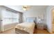 Cozy bedroom with large window, ceiling fan, neutral tones, and stylish bedside table with nautical decor at 7168 W Lenox Cir, Punta Gorda, FL 33950