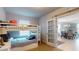 Bright bedroom featuring a bunk bed and open doorway to living area with elegant chandelier at 7168 W Lenox Cir, Punta Gorda, FL 33950