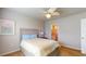 Serene bedroom with ceiling fan, soft lighting, and a glimpse into an en-suite bathroom, all in neutral tones at 7168 W Lenox Cir, Punta Gorda, FL 33950