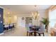Dining area with a chandelier, a round table with seating, and tile flooring at 7168 W Lenox Cir, Punta Gorda, FL 33950