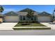 Charming home featuring a well-maintained lawn, a two-car garage, and attractive landscaping at 7168 W Lenox Cir, Punta Gorda, FL 33950