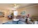 Living room with a comfortable gray sofa, a coffee table, and a view of the dining area and front entrance at 7168 W Lenox Cir, Punta Gorda, FL 33950
