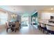 An open-concept living space featuring a dining area, living room, and kitchen with modern finishes and ample natural light at 7168 W Lenox Cir, Punta Gorda, FL 33950