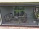 Inviting screened lanai with comfortable seating, a coffee table, and decorative accents at 7168 W Lenox Cir, Punta Gorda, FL 33950