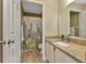 Bathroom with cactus shower curtain and granite vanity at 3300 Loveland Blvd # 1301, Punta Gorda, FL 33980